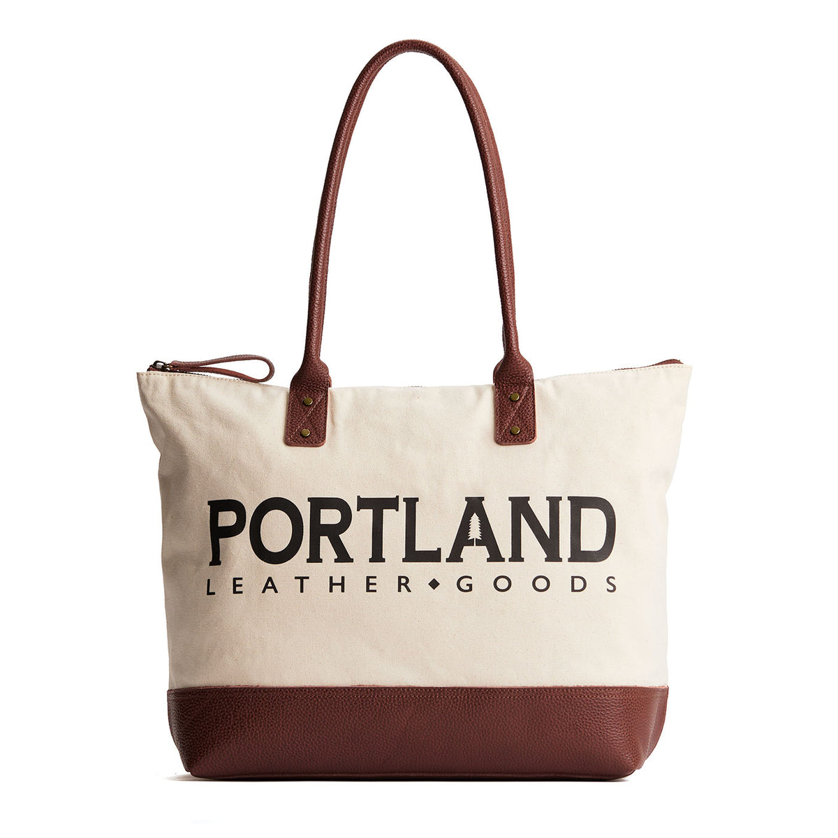 Canvas tote with zipper, leather bottom, and leather handles on a white background
