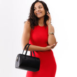 Black Large | Model wearing mini duffle shaped handbag with crossbody strap