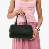 Evergreen Large | Model holding mini duffle shaped handbag with crossbody strap