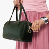 Evergreen Large | Model holding mini duffle shaped handbag with crossbody strap