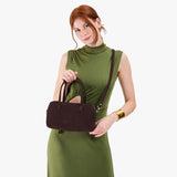Velvet Brown Large | Model holding mini duffle shaped handbag with crossbody strap