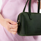 Evergreen Small | Model holding mini duffle shaped handbag with crossbody strap
