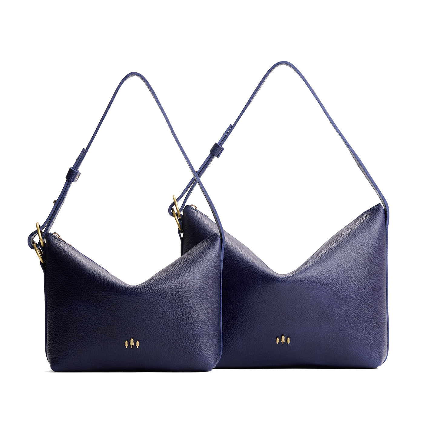 Cobalt | Size comparison shot of small and large slouchy leather shoulder bags with zipper opening and three metal tree emblems