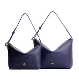 Cobalt | Size comparison shot of small and large slouchy leather shoulder bags with zipper opening and three metal tree emblems