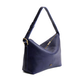 Cobalt Large | Model Wearing medium sized slouchy leather shoulder bag with zipper opening and three metal tree emblems