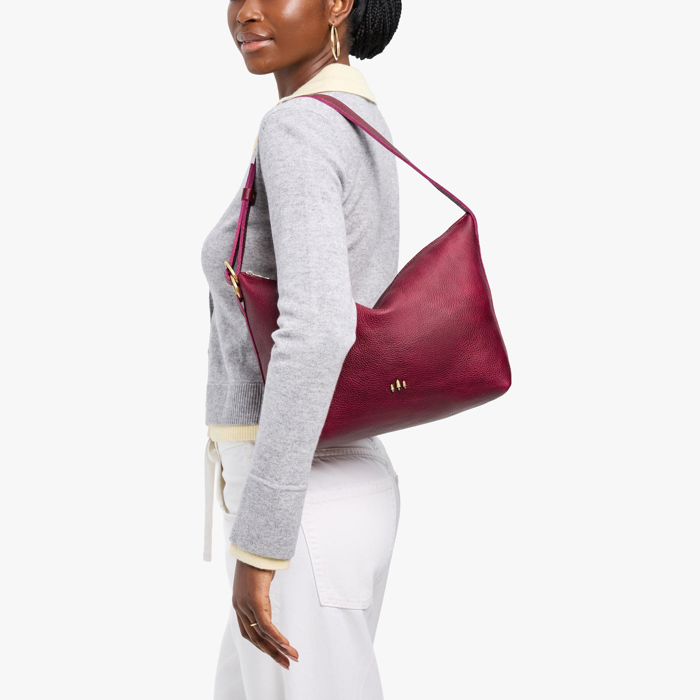 Orchid*Large | Model Wearing medium sized slouchy leather shoulder bag with zipper opening and three metal tree emblems