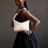 Pebbled Bone Small | Petite slouchy leather shoulder bag with zipper opening and three metal tree emblems