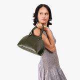 Pebbled Olive Small | Model holding a half circle crossbody bag with handles and removable crossbody strap 