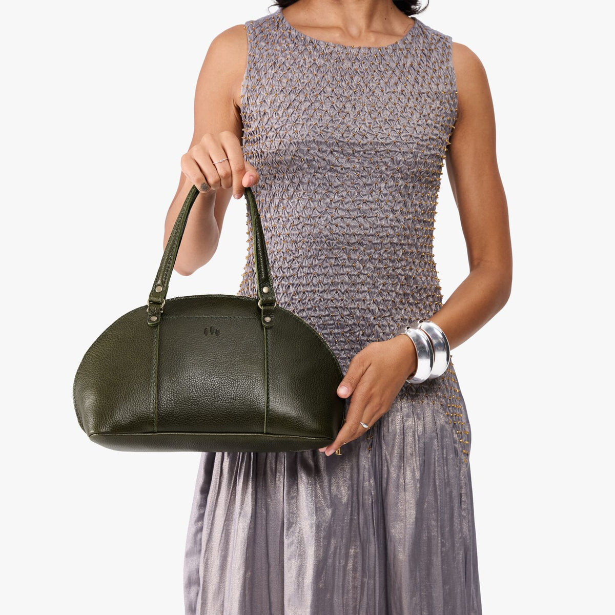 Pebbled Olive*Small | Model holding a half circle crossbody bag with handles and removable crossbody strap 