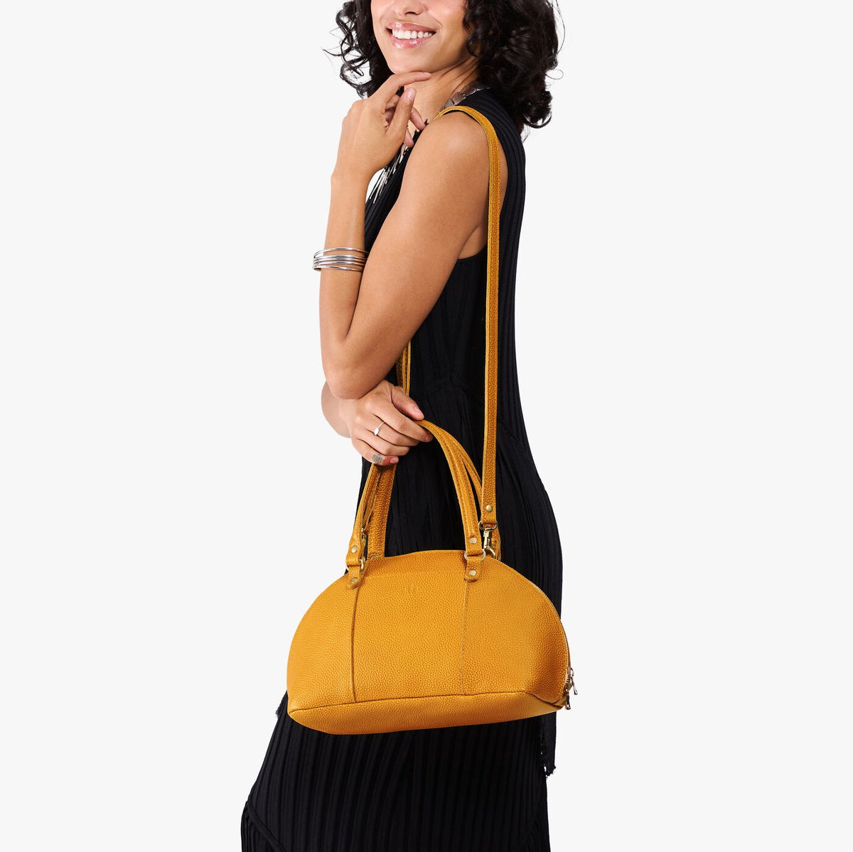 Sunshine*Small | Model holding a half circle crossbody bag with handles and removable crossbody strap 
