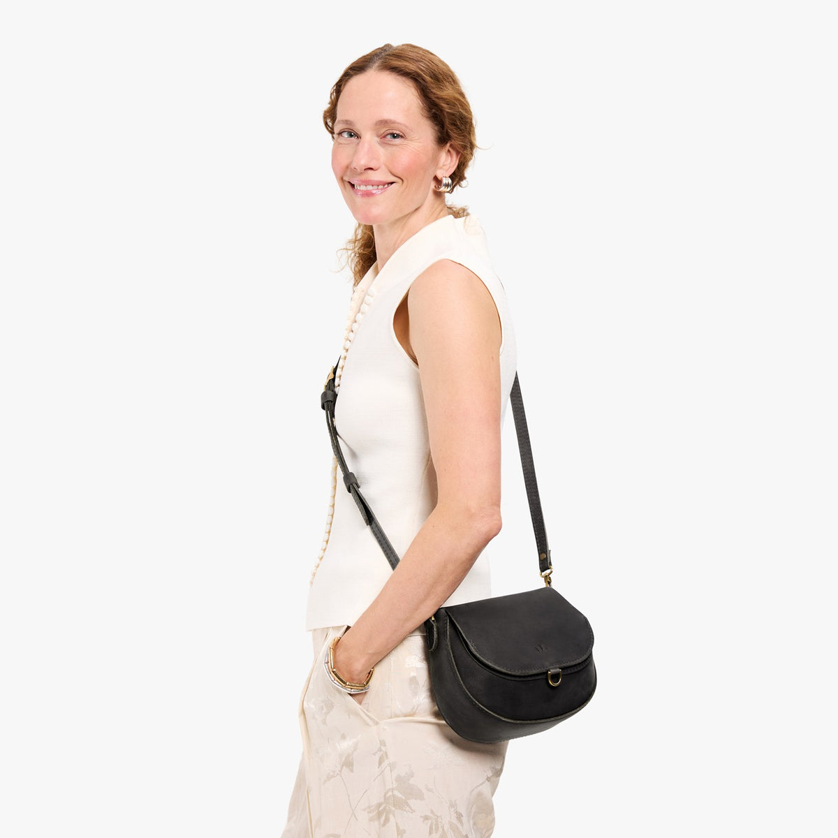 Full Moon*Small | Model wearing a leather Crossbody with a flap and magnetic closure