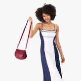Orchid Small | Model wearing a petite leather Crossbody with a flap and magnetic closure