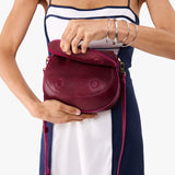 Orchid Small | Model wearing a petite leather Crossbody with a flap and magnetic closure