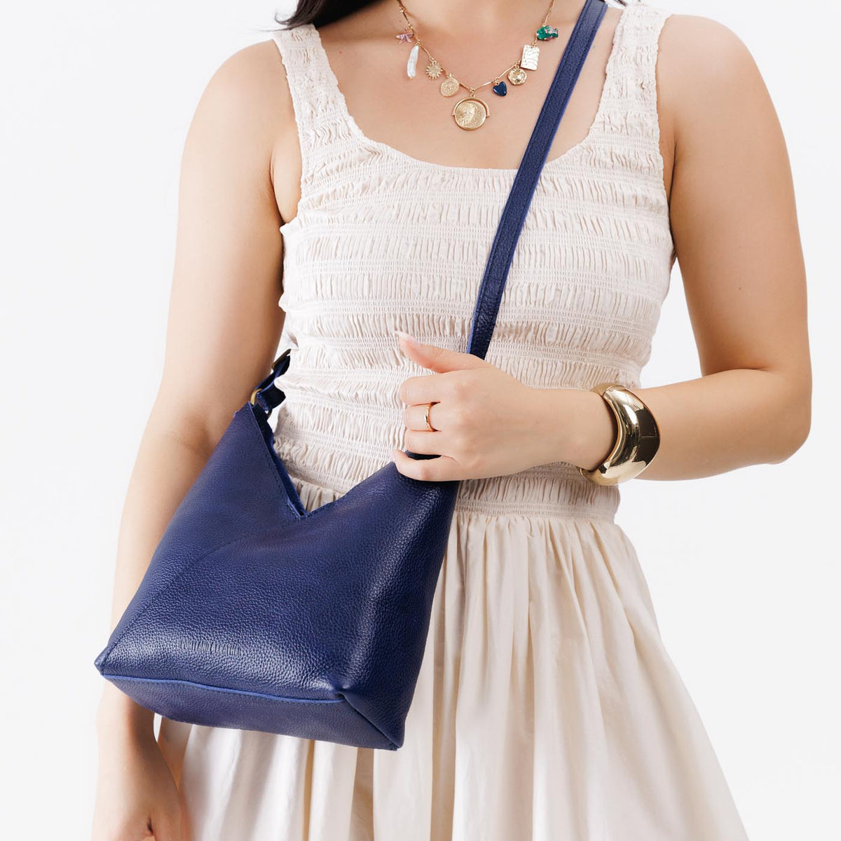 Cobalt*Small | Model wearing petite shoulder bag with adjustable strap and magnetic snap closure