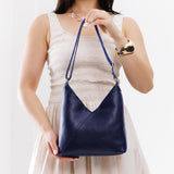 Cobalt Small | Model wearing petite shoulder bag with adjustable strap and magnetic snap closure