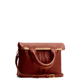 Nutmeg Small | Convertible tote clutch crossbody with two large front pocket and top carry handles folded into a clutch