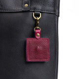 Orchid | Square-shaped leather AirTag holder with snap closure and swivel lobster claw clasp