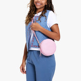 Pinkaboo | Model wearing a circle shaped crossbody bag with top zipper and gold accents
