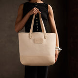 Warm Sand | Model holding canvas tote with leather base and handles