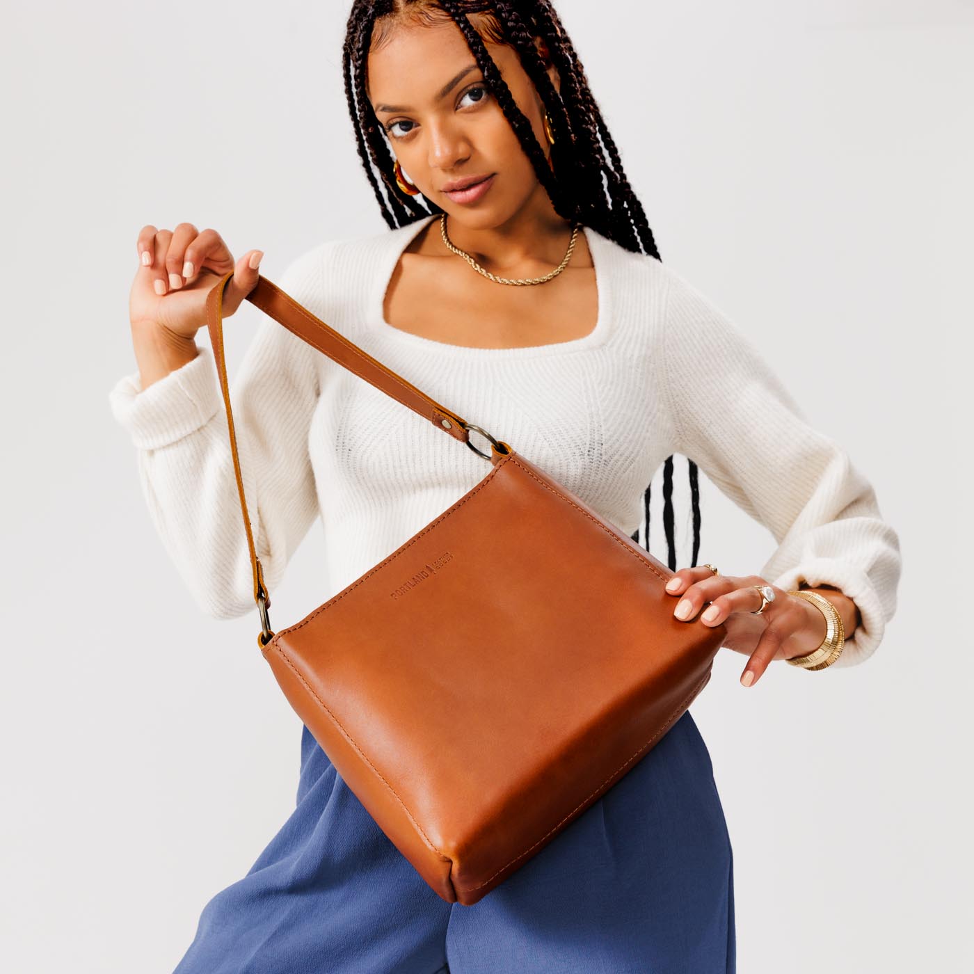 Honey*Small | Model holding triangular shoulder bag with antiqued brass finished hardware