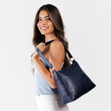 Cobalt Small | Model carrying triangular shoulder bag with antiqued brass finished hardware