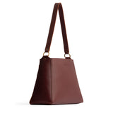 Cognac Large | Large triangular shoulder bag with antiqued brass finished hardware