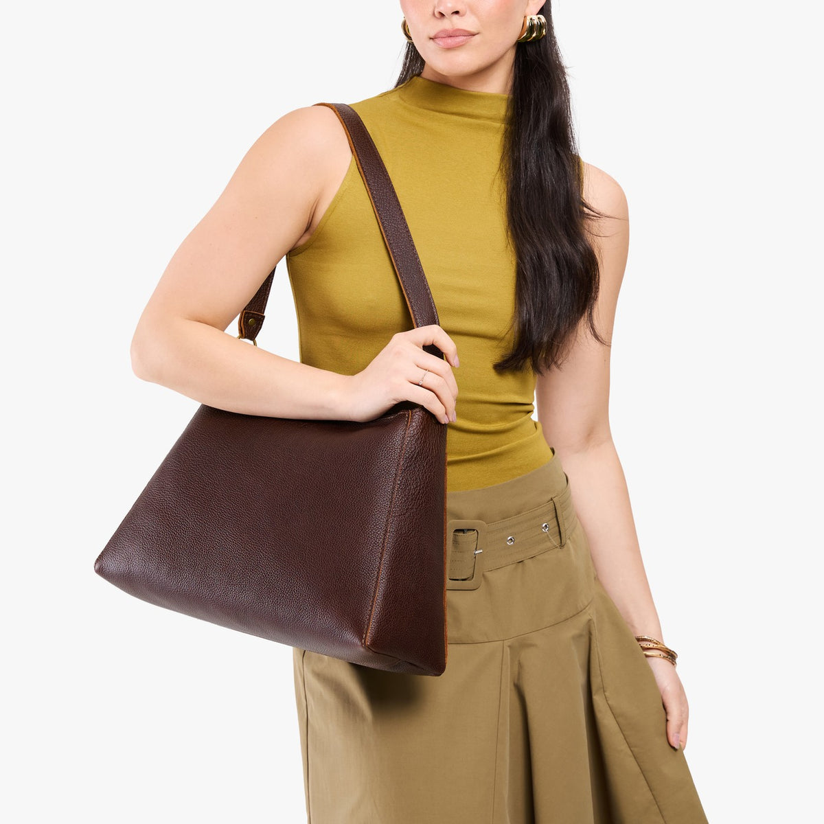 Coldbrew*Large | Model carrying large triangular shoulder bag with antiqued brass finished hardware