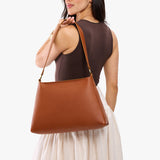 Honey Large | Model carrying large triangular shoulder bag with antiqued brass finished hardware