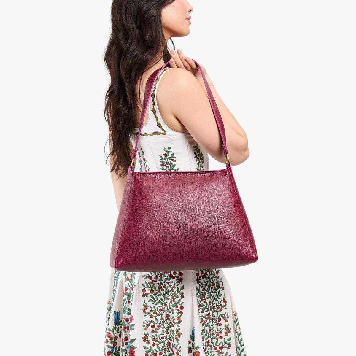 Orchid*Large | Model carrying large triangular shoulder bag with antiqued brass finished hardware