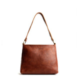Nutmeg Small | Triangular shoulder bag with antiqued brass finished hardware