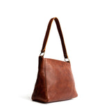 Nutmeg Small | Triangular shoulder bag with antiqued brass finished hardware