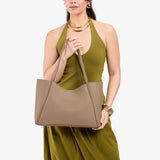 Stone Large | Model holding a large rectangular tote bag
