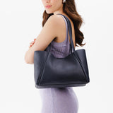 Night Owl Medium | Model holding midsize rectangular tote bag