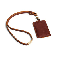 Nutmeg | A leather lanyard attached to a matching card holder on a white background