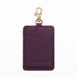 Plum | A leather card holder with a swivel lobster clasp on a white background