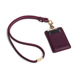 Plum | A leather lanyard attached to a matching card holder on a white background