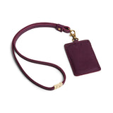 Plum | A leather lanyard attached to a matching card holder on a white background