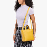 Pomello Zipper | Model wearing crossbody tote bag with snap closure and front pocket