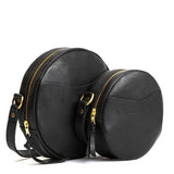 Pebbled--black | Size comparison image of small and large circle shaped crossbody bags with top zipper
